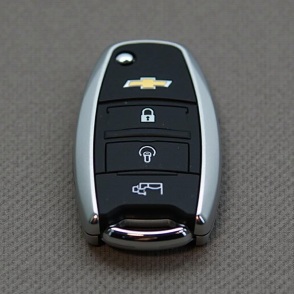 Closeup view of a 2016 Chevy Impala LTZ key fob showing its buttons and design.