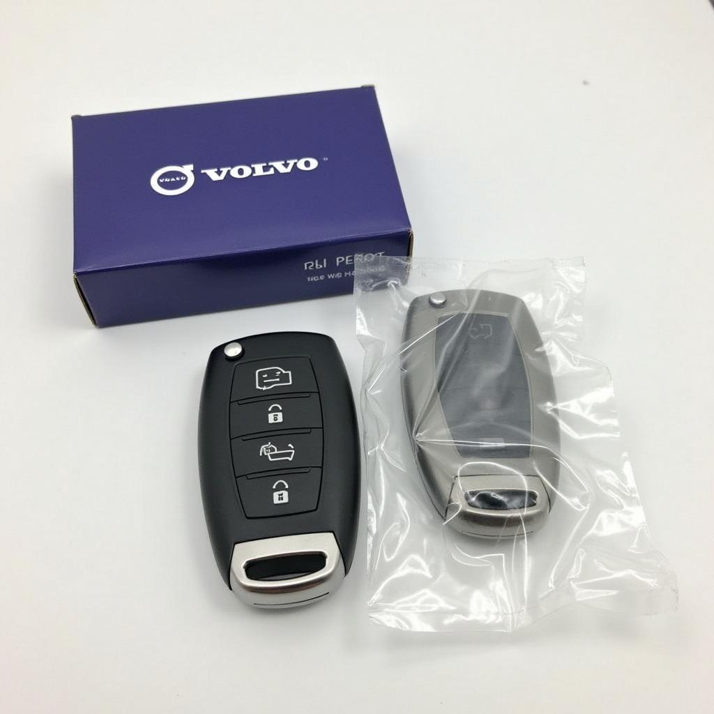 A brand new 2020 Volvo S60 key fob next to its packaging.