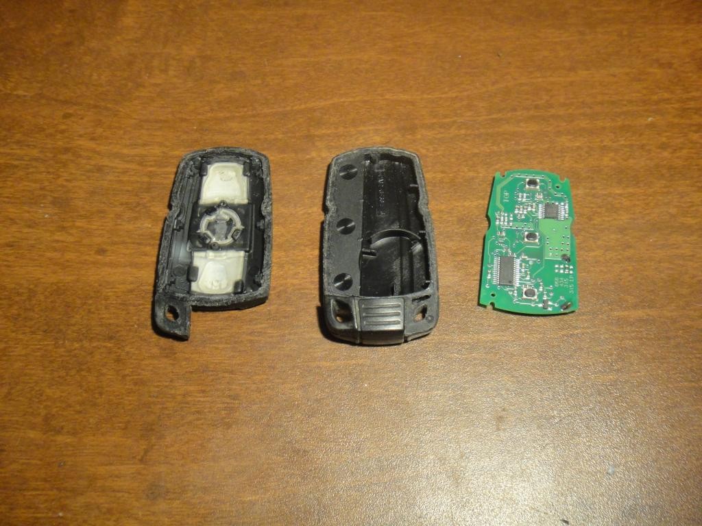 Cutting open the top part of the 2006 BMW 325xi key fob to access the battery compartment