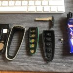 Disassembled car key fob showing internal components for repair