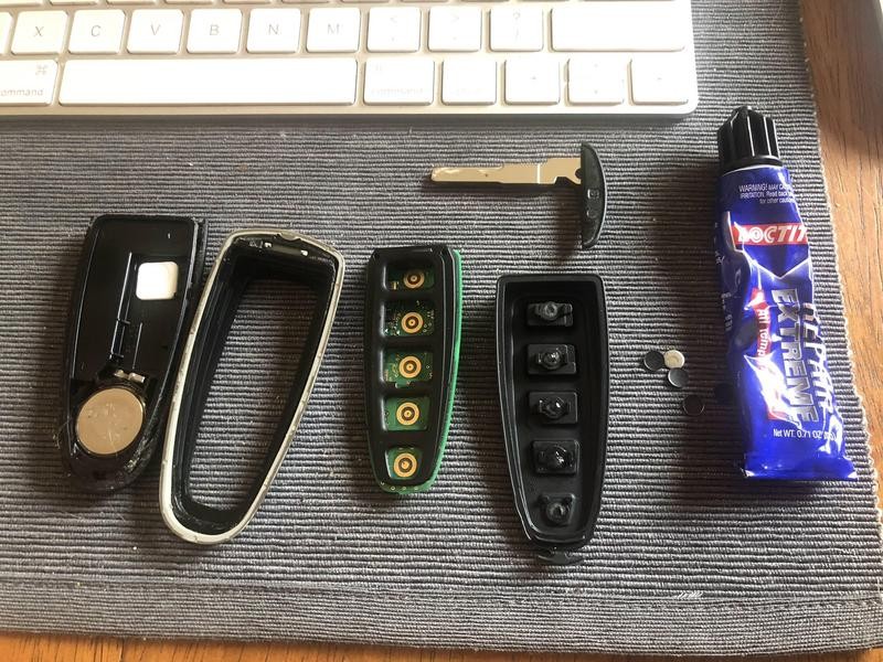 Disassembled car key fob showing internal components for repair