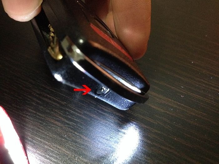 Removing the screw from the Acura TL key fob