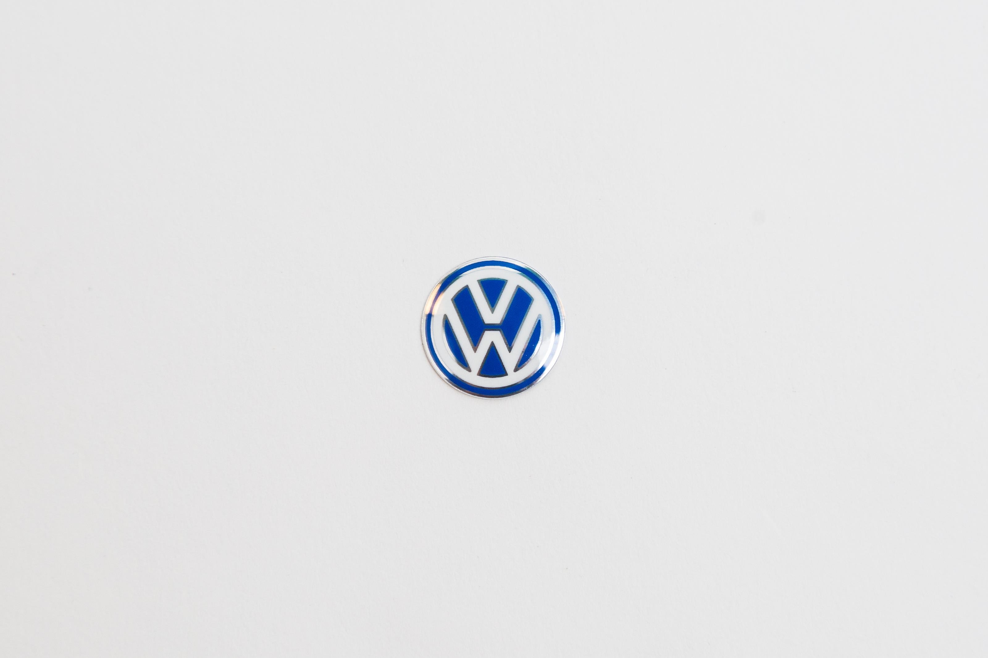 Genuine Volkswagen key fob emblem showcasing the iconic VW logo.