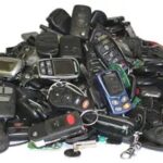 A pile of used car key fobs collected from auto recycling, showcasing the potential for recycling and reuse.