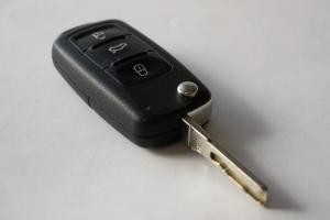 Modern car key fob featuring buttons for remote vehicle access, contrasted with a traditional metal car key.