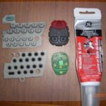 Disassembled key fob remote with tools and materials