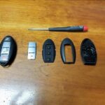 Parts for Nissan 370z key fob shell replacement including new shell and old worn key fob