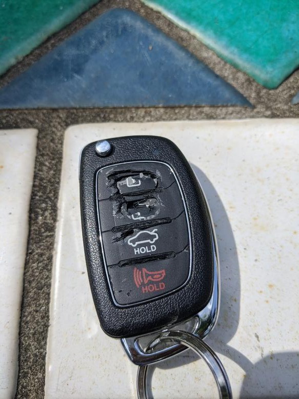 Broken Hyundai Sonata key fob casing with disintegrated buttons.