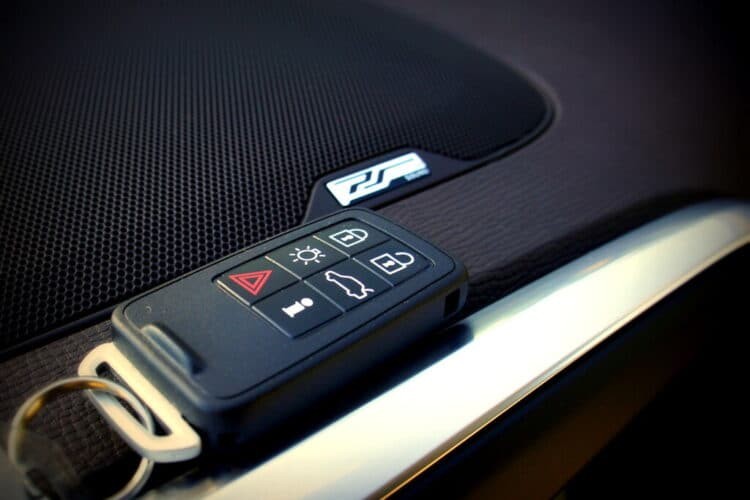 Modern car key fob with buttons for lock, unlock, and trunk release, highlighting the concept of key fob resync.