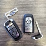 Ford F-150 key fobs illustrating the mechanical key and remote functions, crucial for starting your vehicle with a dead battery, as discussed on Keyfobprog.com.