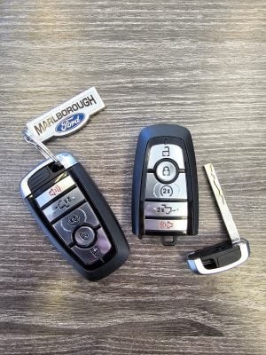 Ford F-150 key fobs illustrating the mechanical key and remote functions, crucial for starting your vehicle with a dead battery, as discussed on Keyfobprog.com.