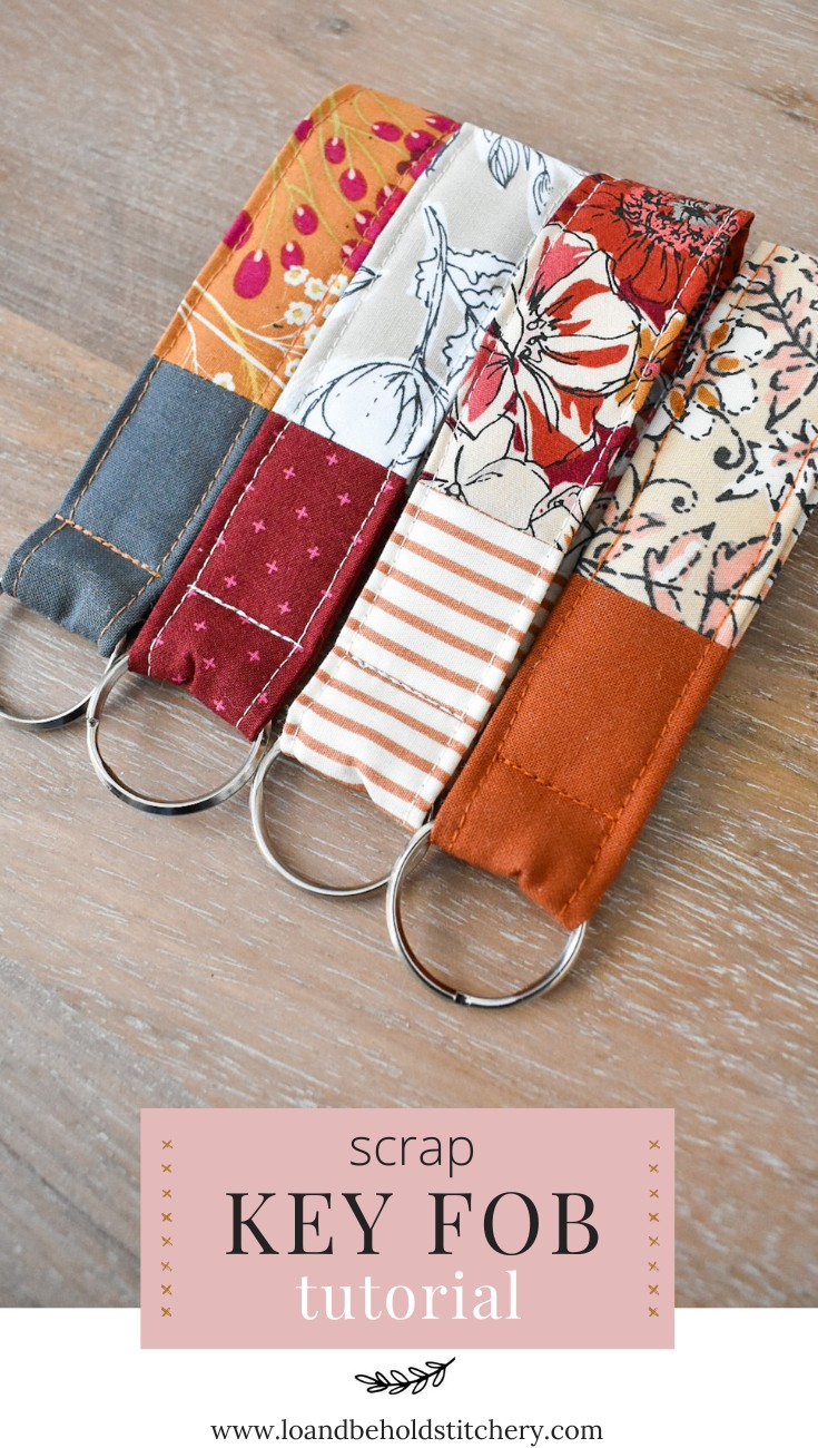 Fabric key fobs displayed on a wooden surface, showcasing various fabric patterns and colors, perfect for DIY enthusiasts and handmade gift ideas.