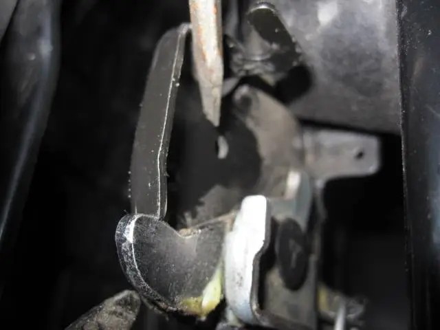 Backside view of Mazda CX-5 hood latch, showing switch tab insertion point